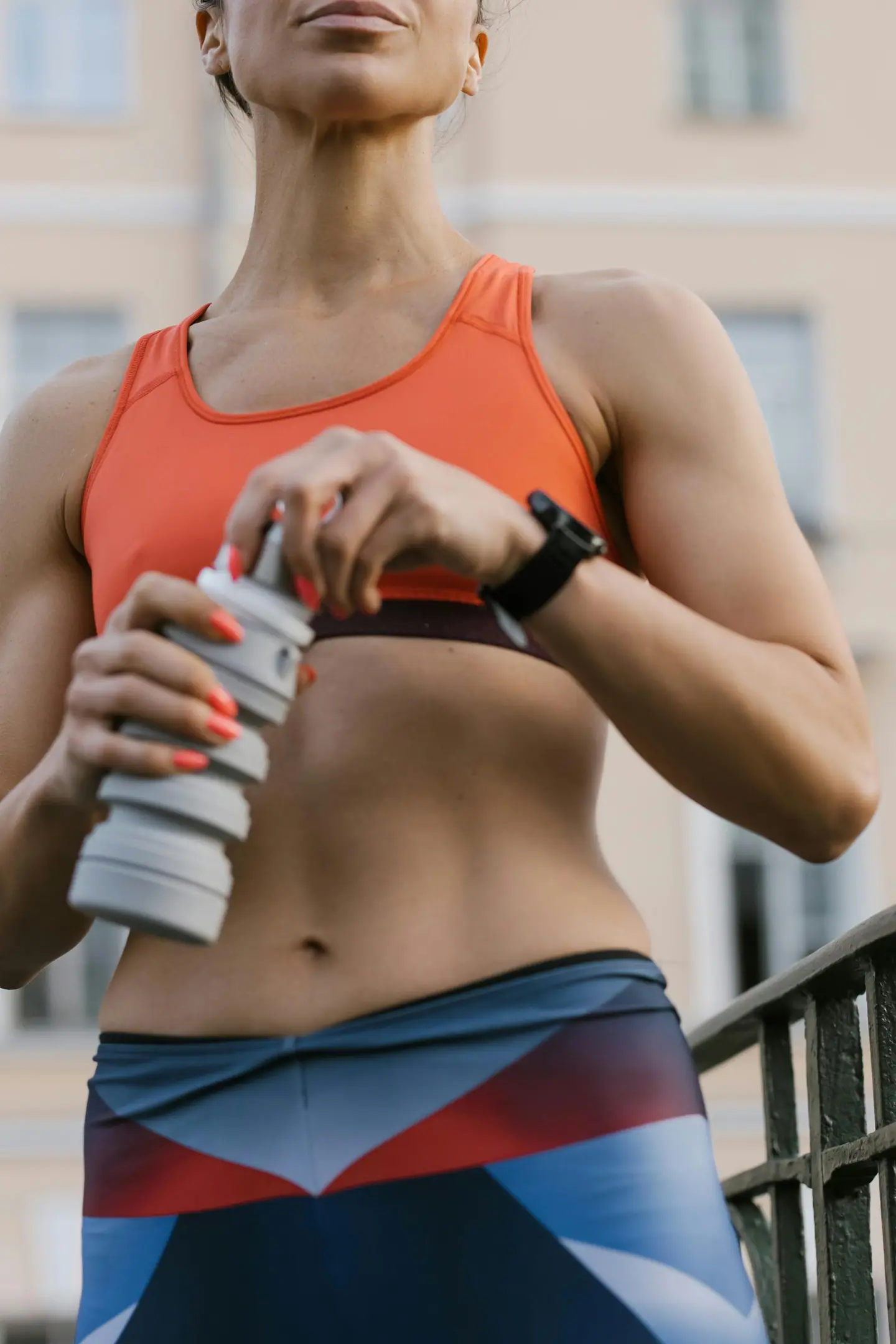 Person holding a water bottle after exercise