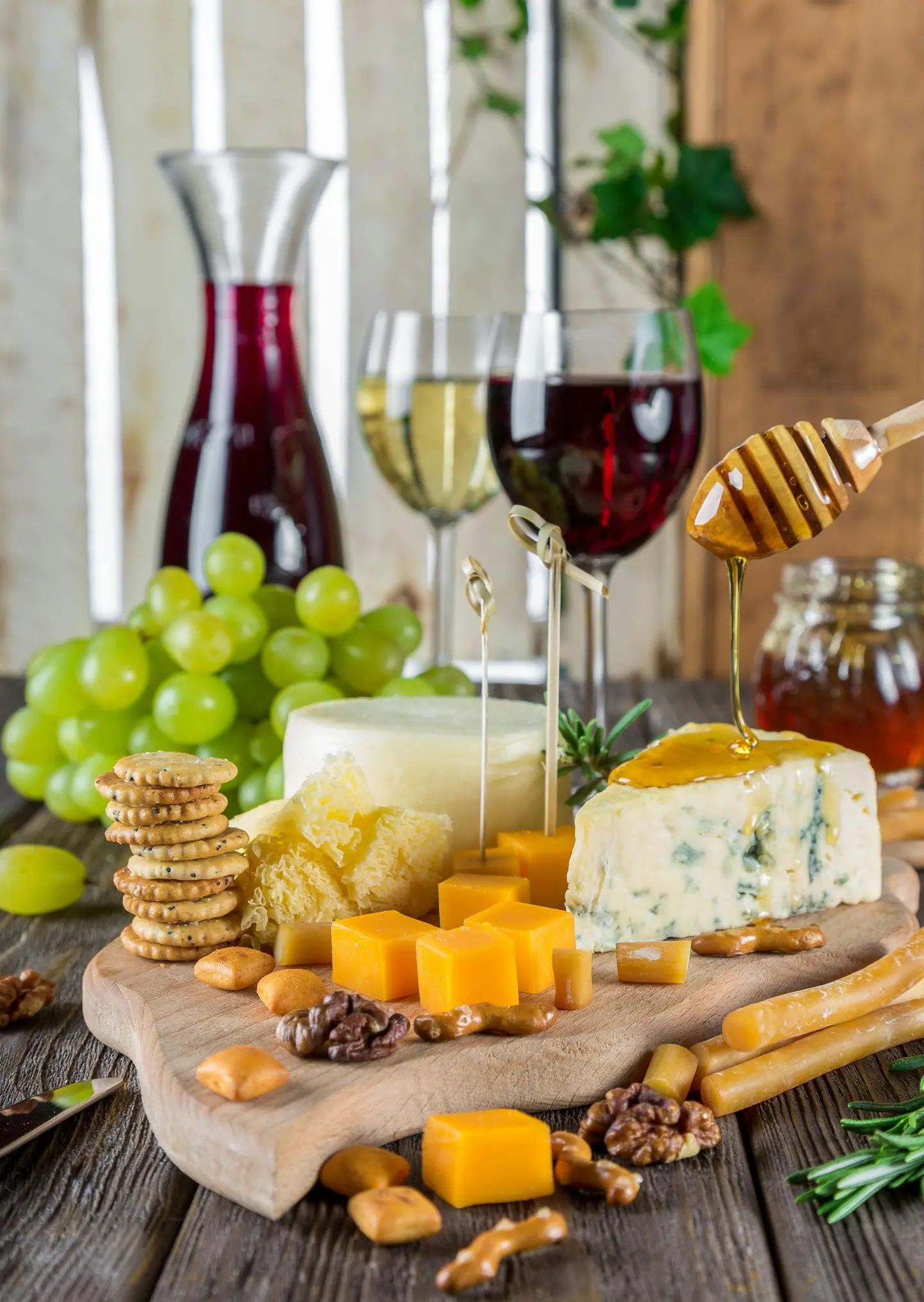 Cheese, grapes, honey and wine on a table